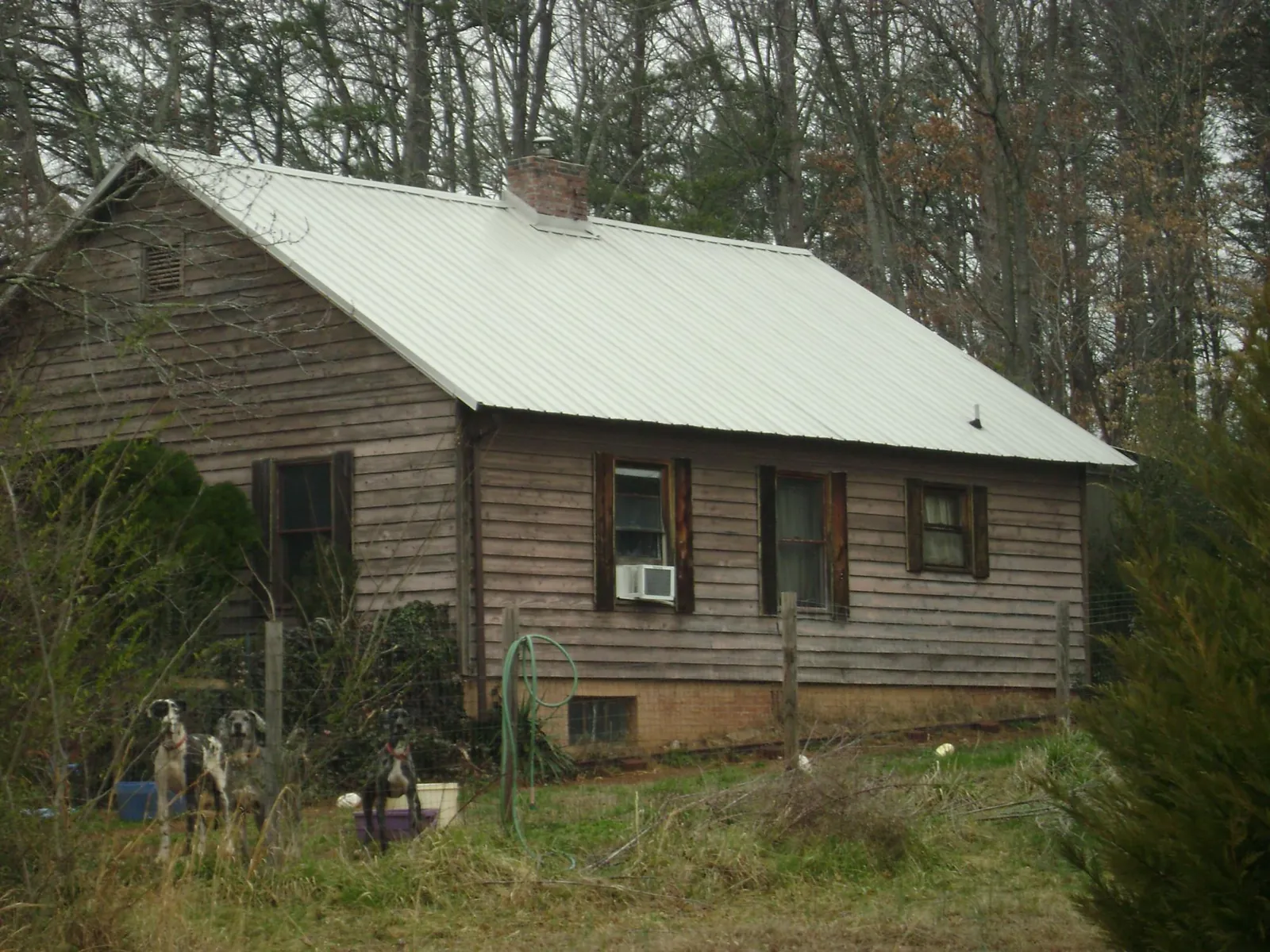 White metal roof on an old wood sided farmhouse, from a Metal Roof Installation job in South Hamilton